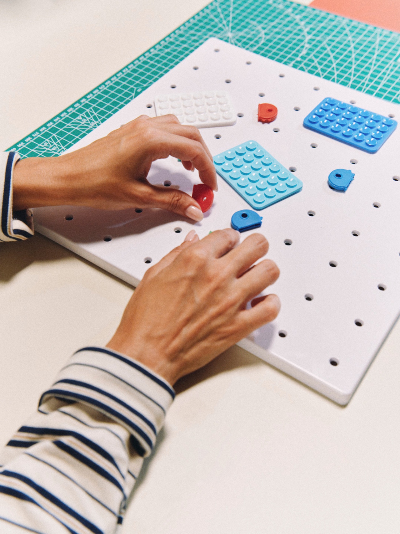 Hands arranging colorful modular parts